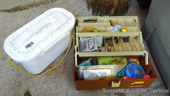 Plano tackle box filled with sinkers, bobbers and fishing lures and more.