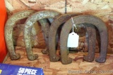 Four throwing horseshoes.