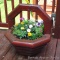 Well made patio or deck planter is 2-1/2' tall. Comes with a nice variety of flowers. Bring a hand