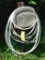 Suncast Hose Hangout wall mount hose keeper plus a length of garden hose. Please bring tools to