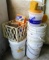 Stack of assorted buckets and a crate with roof cement, some patch cement and some Terro ant killer.