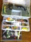 Three plastic bait boxes filled with baits; fishing scale largest box is 10