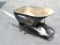 True Value wheel barrow is in good shape with weathered handles.