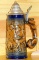 Covered beer stein made in West Germany shows a wild boar hunting scene and has a fox handle. Bottom