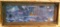 Rustic barn board frame surrounds a wolf and cabin jigsaw puzzle. 45