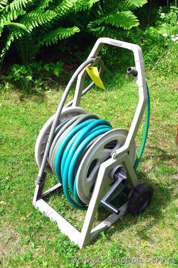 Suncast HoseMobile garden hose caddy, plus a length of garden hose.