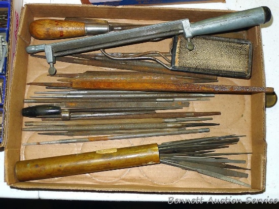 Round chain saw files; file cleaners; brass tube filled with small files.