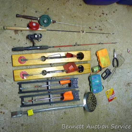 Five gallon pail filled with ice fishing poles, tip-ups, lures, ice scoop and more.
