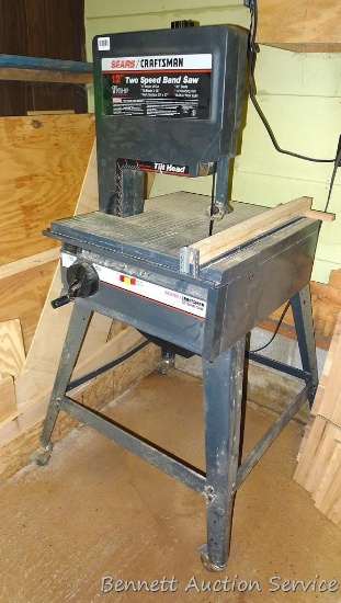 Sears Craftsman 12" 2 speed bandsaw. 1-1/4 HP, mounted on a metal stand with rolling casters. 28" x