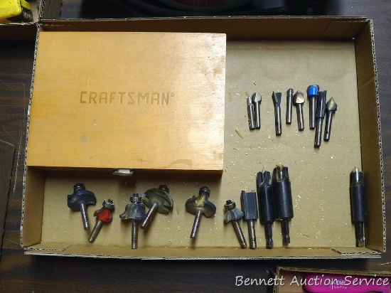 Router bits; wooden storage box marked Craftsman.
