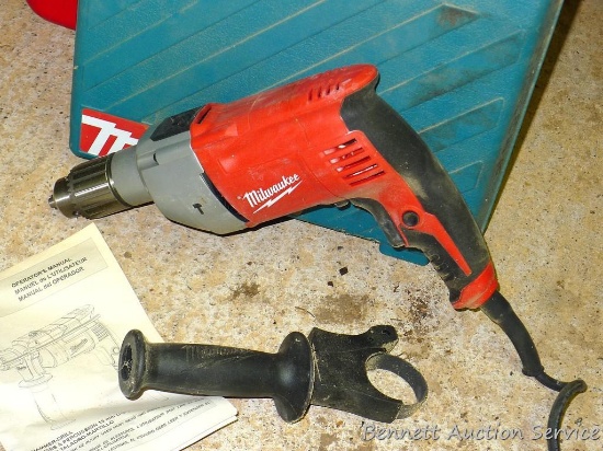 Milwaukee 1/2" reversible hammer drill model 5376-20. Includes extra handle and Makita carrying