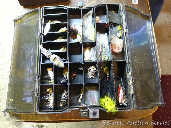 Plano Phantom tackle box filled with lots of lures. Box has double lids on each side and opens on