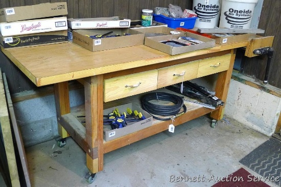 Nice woodworking bench on rollers 80" x 32" x 34" tall. Has 3 drawers and a 13" vise.