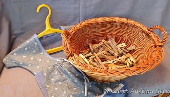 Wicker basket 16" x 12" x 6-1/2"; clothespin bag 18" x 20"; Clothespins.