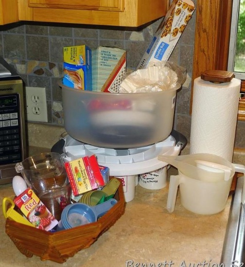 Cake keeper, paper towel holder, food coloring, measuring cups, parchment paper, cups, ash tray
