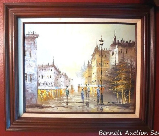 Signed cityscape painting is in great shape and measures approx. 23" x 26" over frame. Some scuffs