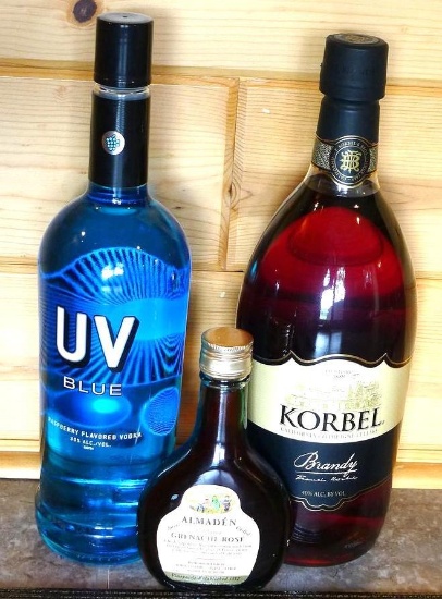 No shipping. Huge bottle Korbel brandy; liter bottle of UV Blue raspberry flavored vodka; small gift