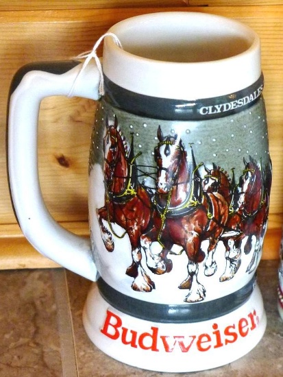 Two Budweiser beer steins. One is 1985 A series, the other is 1983 Clydesdales 50th Anniversary.