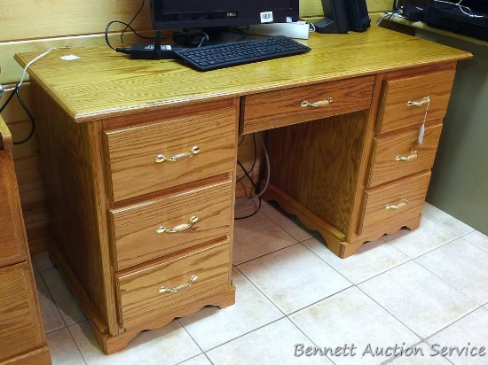 Nice seven drawer wooden desk is in very good condition. A few office supplies included, see photos.