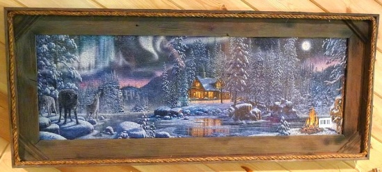 Rustic barn board frame surrounds a wolf and cabin jigsaw puzzle. 45" x 18" over frame.