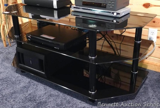 Super modern black glass entertainment stand measures 51" wide x 22" deep x 23" high. Unit is in