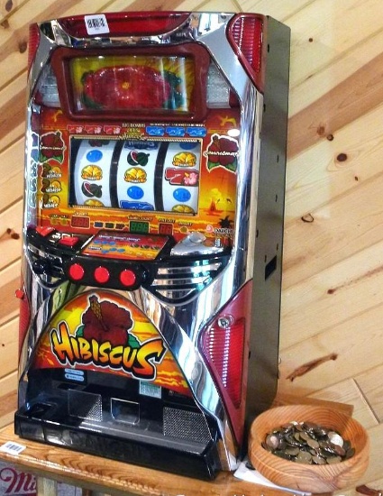 Daiichi Hibiscus slot machine is 32" tall and appears in good condition. Comes with a bunch of