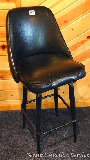 Steel framed swiveling bar stool is 43" tall. Nice and sturdy, vinyl in good condition.