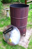 Burn barrel with stand and lid.