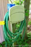 Suncast HoseHangout wall mount hose keeper with storage and garden hose. Please bring tools to
