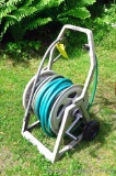 Suncast HoseMobile garden hose caddy, plus a length of garden hose.