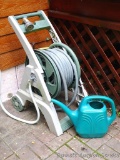 Ames hose reel with hose and sprayer nozzle.