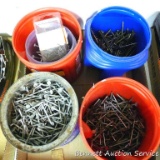 Containers partially full of nails. Includes roofing nails, screws and more.