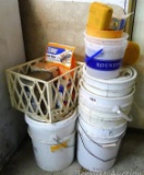 Stack of assorted buckets and a crate with roof cement, some patch cement and some Terro ant killer.