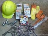 Chain saw chains, some are new in package; chain saw files; spark plug wrenches; wedges; hard hat;