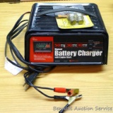 Schumacher manual battery charger with engine start model SE-1250 for 12V batteries. Has dent in