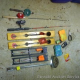 Five gallon pail filled with ice fishing poles, tip-ups, lures, ice scoop and more.