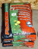Two unopened 32 pound bags of Weed'n Feed.
