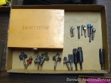 Router bits; wooden storage box marked Craftsman.