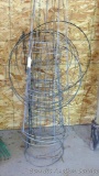 Nine 2' and 3' tall tomato cages; other plant stakes;
