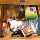 Junk drawer items including vases, steel wool soap pads, markers, small level, liquid nails;