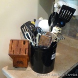 Kitchen crock with utensils including grater, whisk, spatulas, serving spoons, ladles, tongs, more;