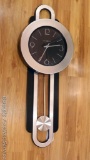 Howard Miller battery operated wall clock is in good condition.