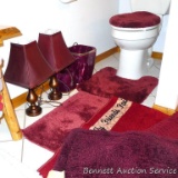 Cranberry bathroom accessories including several throw rugs, tissue box cover, wastebasket, two side