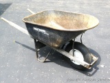 True Value wheel barrow is in good shape with weathered handles.