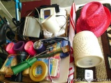 General household items including reading glasses, a sparkly hat, blood pressure cuff, umbrella,