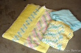 Two handmade afghans, plus another blanket. Larger afghan is approx. 4' x 4'.