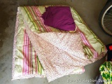 Pretty twin sized comforter, plus dust ruffle. A few light stains noted.