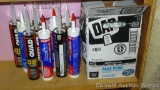 Case of DAP Alex Plus caulk, mostly full. Plus other tubes caulk, adhesive, etc. All stored inside.