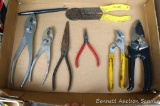 Assorted pliers and a bypass pruner.