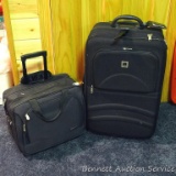 Two nice clean wheeled suitcases, one has a torn zipper at corner, other zippers appear good. Larger